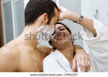 morning routine: the guy shaving and the girl (trying to) apply her make-up
