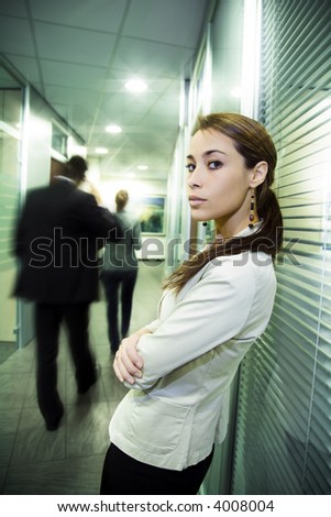 Office life: young business woman in a crowded office