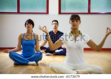 health club: man and women doing yoga