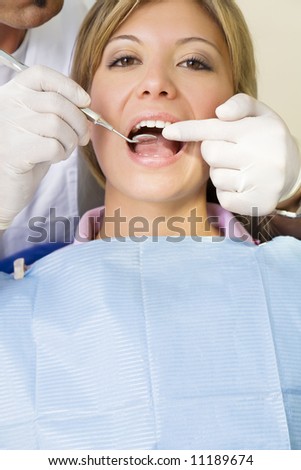 dentist using an angled mirror. Copy space. The focus is on woman\'s teeth
