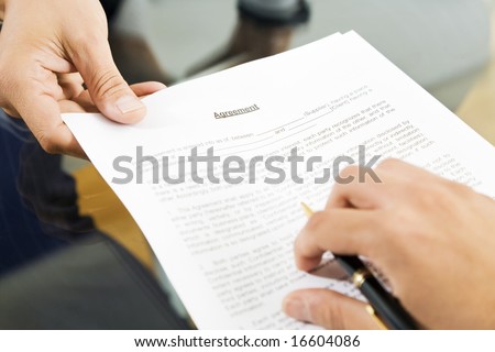 Businessman holding agreement for signature. Close up