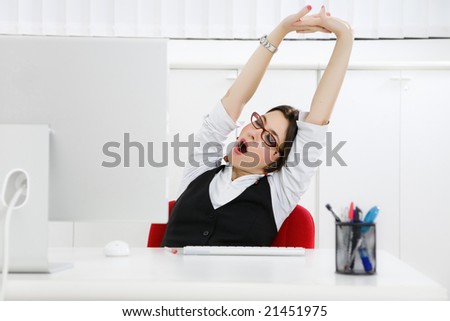 Young businesswoman sitting at desk yawning. Copy space