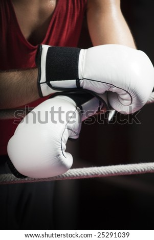 cropped view of boxer leaning on ropes. Copy space