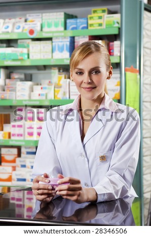 portrait of young adult pharmacist looking at camera