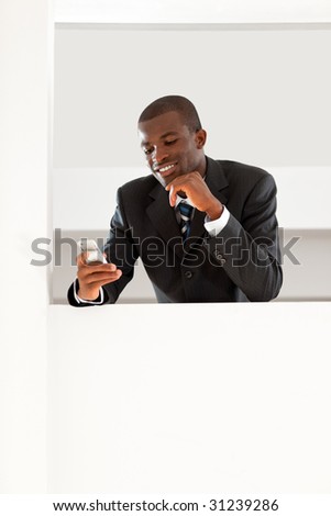 young adult afro-american businessman reading emails on his smartphone indoors. Copy space
