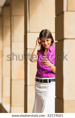 young adult businesswoman reading phone message on mobile phone. Copy space
