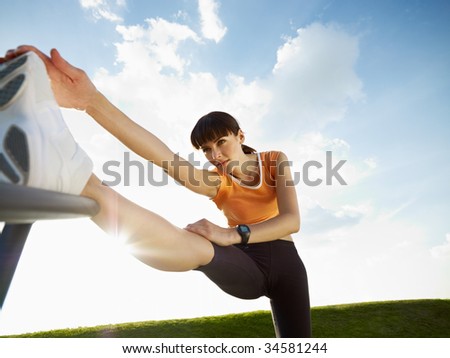 woman doing stretching outdoors at sunset. Low angle view, copy space