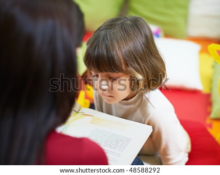 2-3 years girl listening to fairy tale in kindergarten. Horizontal shape