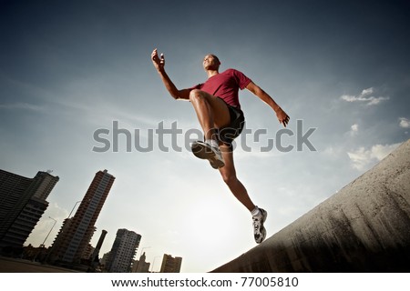 Latin american athlete running in Havana, Cuba. Horizontal shape, full length, low angle view