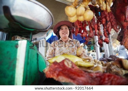 Asian woman selling meat, beef, pork and chicken at street restaurant in Phnom Penh, Cambodia
