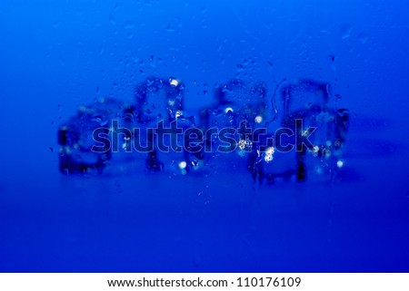 Drops of water with blurred ice cubes