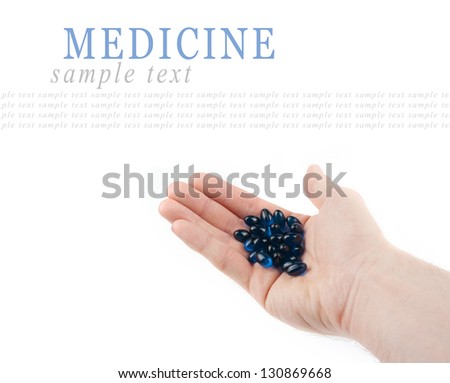 Blue pills on hand isolated on white background