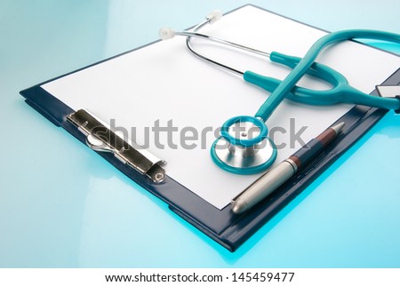 Stethoscope and empty document in a clipboard on blue background