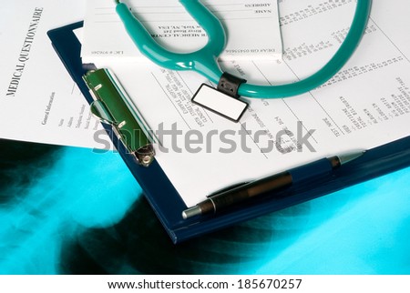 Medical documents (blood test, prescription and medical questionnaire) with a stethoscope on Xray photo of lungs