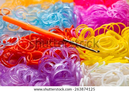 Creative set of multi-colored rubber bands and a hook tool for making bracelets
