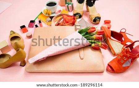 Large Simple Pink Woman\'s Business Briefcase with Various Items That Could be Inside in it on Pink Background