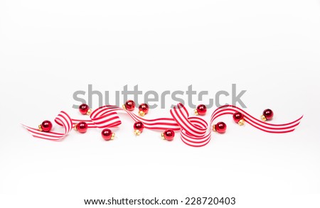 Red Striped Ribbon and Mini Ornaments on White Background for Christmas Themed Design