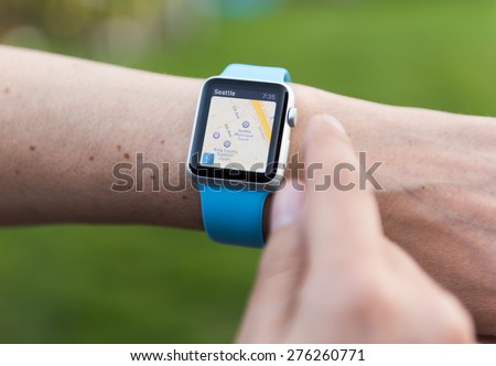 SEATTLE, USA - May 8, 2015: Man Using Maps App on Apple Watch While Outside.
