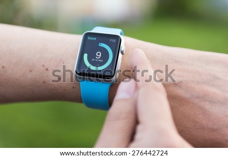 SEATTLE, USA - May 9, 2015: Man Using activity App on Apple Watch to See Calories Burned During Day.