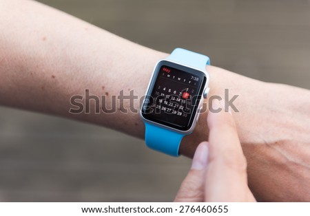 SEATTLE, USA - May 8, 2015: Man Using Calendar App on Apple Watch to Check Schedule.