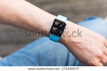 SEATTLE, USA - May 8, 2015: Man Using World Clock App on Apple Watch While Outside. Seattle, USA  and Valetta, Malta times.