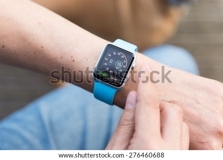 SEATTLE, USA - May 8, 2015: Man Using Stopwatch App on Apple Watch While Outside.