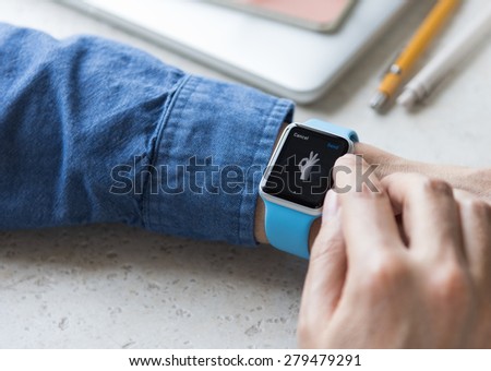 SEATTLE, USA - May 19, 2015: Man Wearing Sport Apple Watch with Blue Rubber Band.