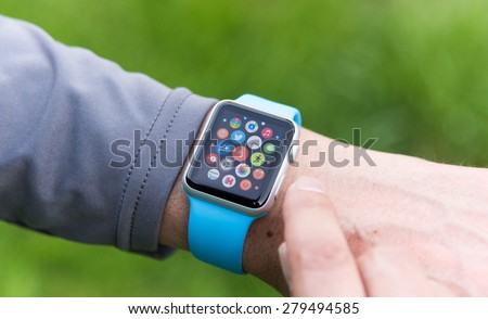 SEATTLE, USA - May 19, 2015: Man Using Apple Watch While Outside. Multiple Apps View.