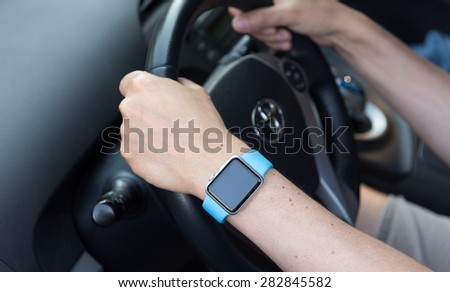 SEATTLE, USA - May 30, 2015: Man Wearing Apple Watch While Driving Toyota Prius