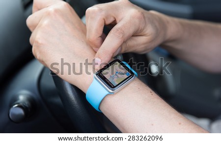 SEATTLE, USA - May 30, 2015: Man Using Maps App on Apple Watch While Driving Car