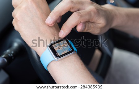 SEATTLE, USA - June 3, 2015: Man Using Maps App on Apple Watch While Driving Car