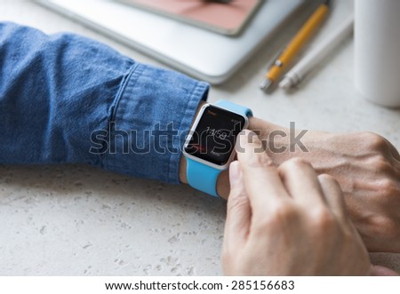 SEATTLE, USA - June 6, 2015: Man Wearing Sport Apple Watch with Blue Rubber Band.