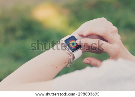 SEATTLE, USA - July 22, 2015: Woman Using Activity App on Apple Watch. Checking Progress and Goals Accomplished.