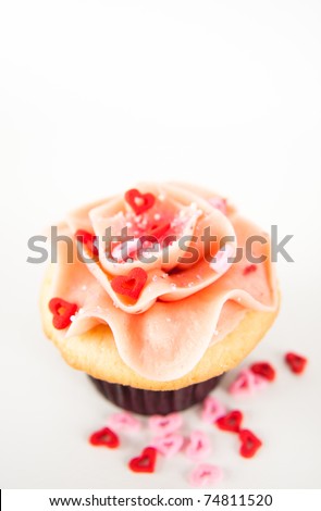 Vanilla Strawberry Cupcake with Heart Candy and Pink Sprinkles