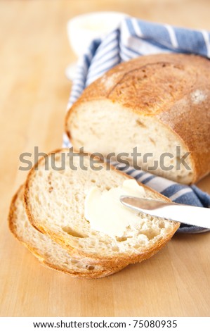 Freshly Baked Loaf of Yellow Potato Bread with Some Butter