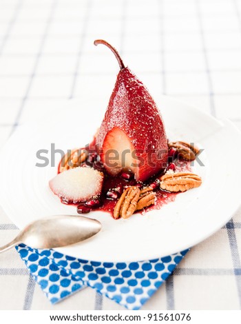 Simple Paleo Style Dessert Pear Poached in Pomegranate Juice Served with Nuts and Seeds