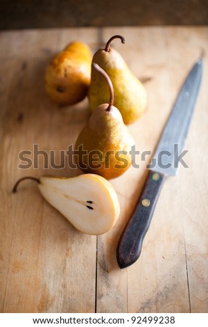 Three Organic Bosc Pears on Old Cutting Board