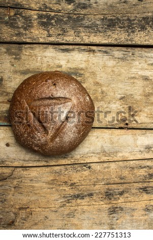 Bakery background. Rye bread on old wooden board