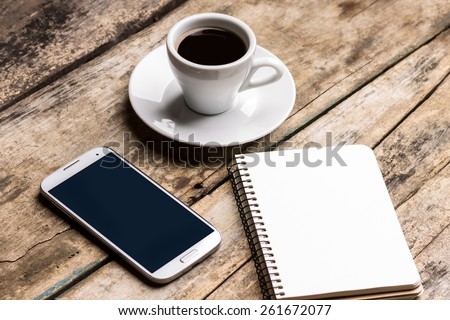 Mock up set of smartphone, notebook and cup of coffee. Coffee break background