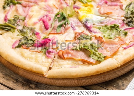 Sliced Pizza on wooden background. Recipe and menu background