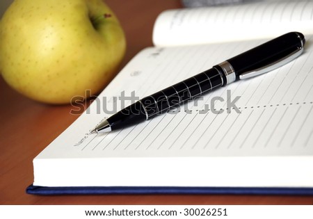 organizer with metallic black pen on desk