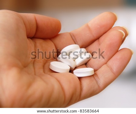 white round pills on hand