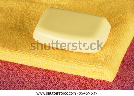 magenta and yellow towels with white soap bar