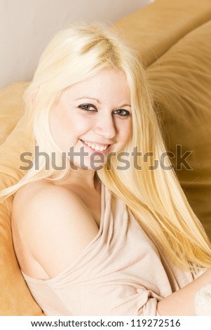 Beautiful smiling blonde woman on the bed