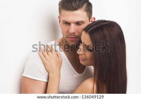 Young sexy heterosexual couple embracing