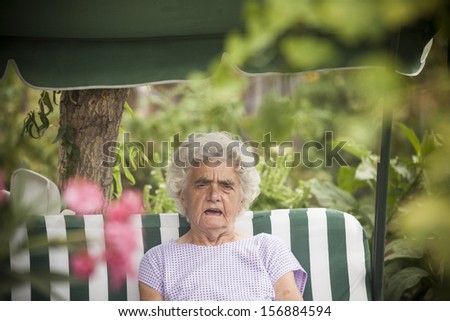 Very old caucasian woman relaxing in the garden