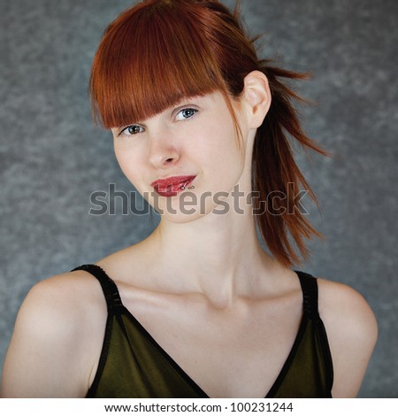 Portrait of a young woman with long red hair