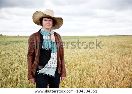 Country Woman with straw hat on the field