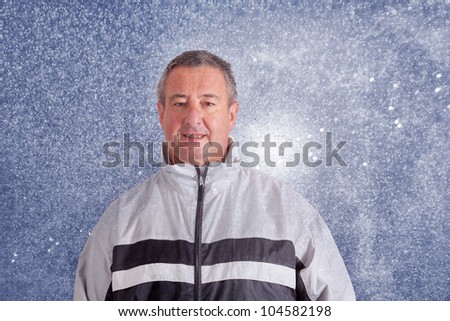 Man in rain clothing runs in the rain
