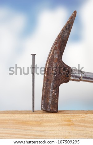 Hammer and nail with wooden board